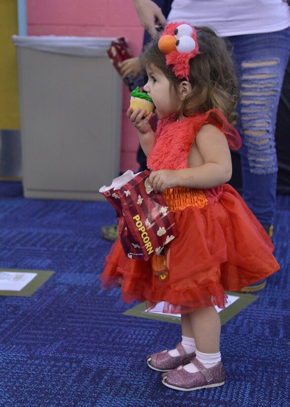 Evangeline Parrella munches on a cupcake from the cake walk Oct. 23 at Bootastic. The annual Halloween event, sponsored by the Youth Center, provided a free night of games, prizes, safe trick-or-treating and other fun events for people of all ages. (Photo by Jamie Burnett)