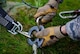 A cable and antenna systems technician from the 1st Communications Maintenance Squadron secures a rope before lowering a simulated victim from a telephone tower Oct. 9, 2015, at Ramstein Air Base, Germany. Cable and antenna maintenance technicians trained on multiple tower and ground emergency scenarios. (U.S. Air Force photo/Senior Airman Nicole Sikorski)