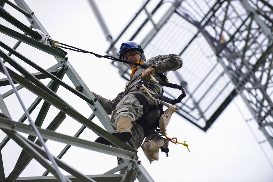 Senior Airman Abraham Pulido, 1st Communications Maintenance Squadron cable and antenna systems technician, hangs from a telephone tower Oct. 9, 2015, at Ramstein Air Base, Germany. Cable and antenna maintenance technicians at the 1st CMXS are required to take Specialized Technical Aided Rescue Training at least once annually. (U.S. Air Force photo/Senior Airman Nicole Sikorski)