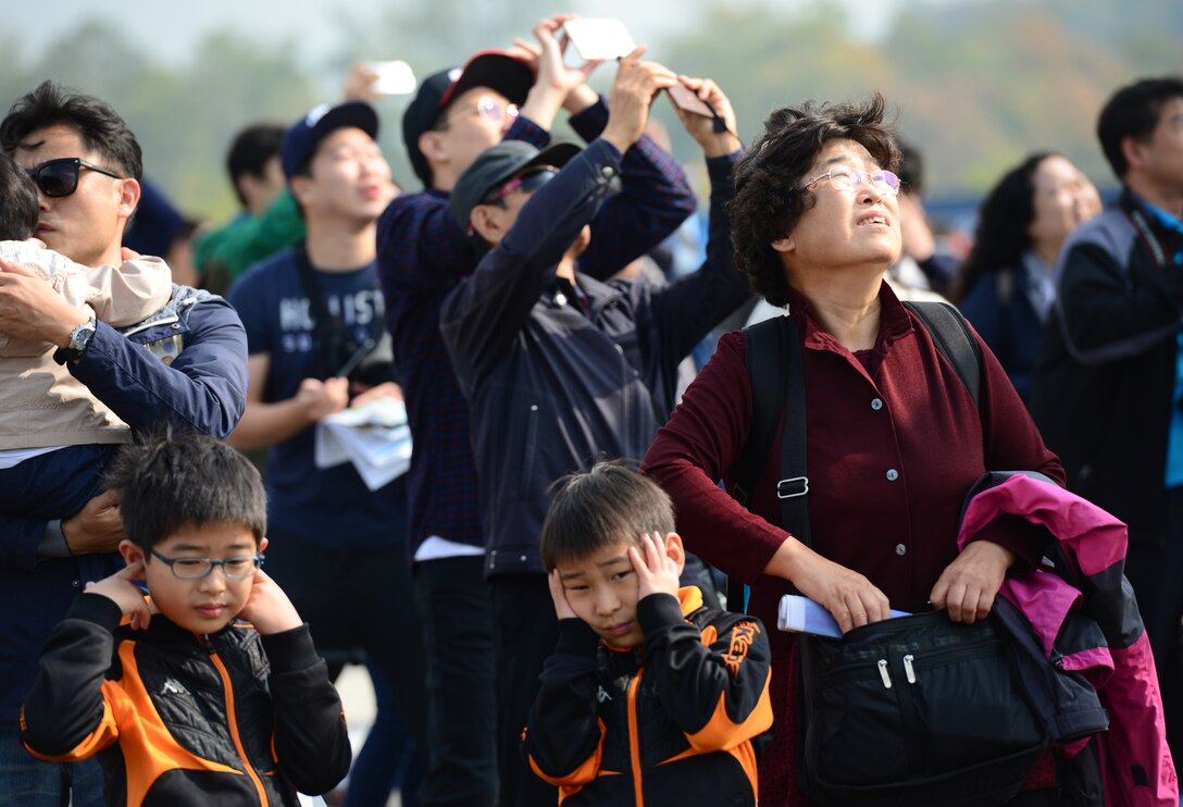 During the various flyovers, demonstrations and aerial feats,- local Koreans kept their eyes on the sky while the noise proved too much for others at the 2015 Seoul International Aerospace and Defense Exhibition held at Seoul Airport, Republic of Korea, Oct. 24, 2015. Included in these displays were flyovers by the F-22 Falcon and the C-17 Globemaster III. 
(U.S. Air Force photo/Staff Sgt. Amber Grimm)