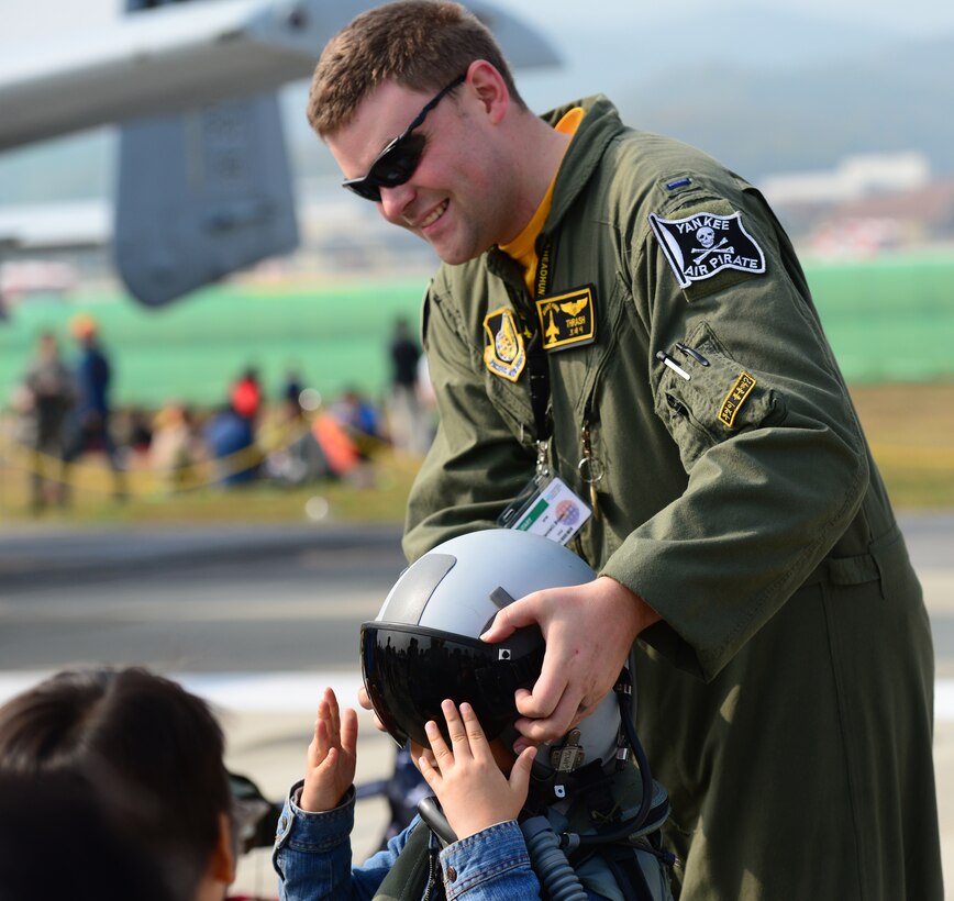 1st Lt. Daniel Brom, 80th Fighter Squadron, Kunsan Air Base, Republic of Korea, helps a local Korean boy try on a flight helmet at the 2015 Seoul International Aerospace and Defense Exhibition held at Seoul Airport, Republic of Korea, Oct. 24, 2015. The Seoul ADEX gives American service members a chance to interact with the Korean public while showcasing their outstanding aircraft and equipment.
(U.S. Air Force photo/Staff Sgt. Amber Grimm)