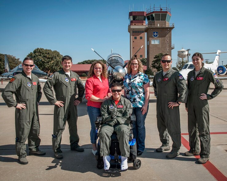 Damon Journey and his family (center) join 8th Flying Training Squadron cadre on the flightline at Vance Air Force Base, Oklahoma, Oct. 15. Journey was a guest of the 8th FTS as a Pilot for a Day. (U.S. Air Force/ Staff Sgt. Nancy Falcon)