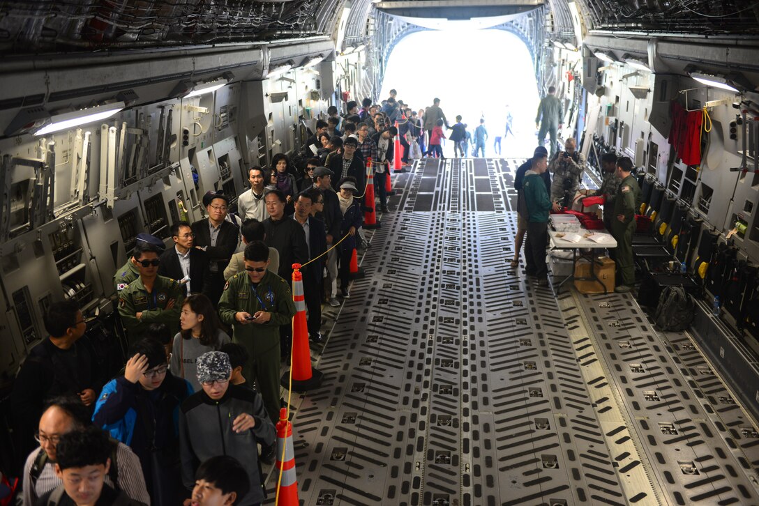 Korean civilians and service members line up inside of a C-17, from Joint Base Pearl Harbor-Hickam, Hawaii, for a chance to visit the cockpit and see the workings of this aircraft at the 2015 Seoul International Aerospace and Defense Exhibition held at Seoul Airport, Republic of Korea, Oct. 24, 2015. The C-17 performed demonstrations flights for the crowds displaying the crafts high and low speed maneuverability at varying altitudes. 
(U.S. Air Force photo/Staff Sgt. Amber Grimm)