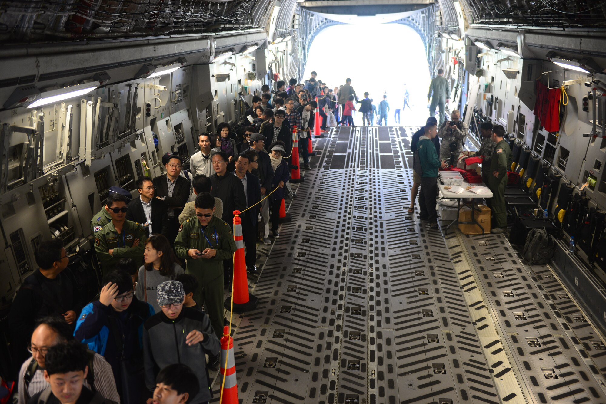 Korean civilians and service members line up inside of a C-17, from Joint Base Pearl Harbor-Hickam, Hawaii, for a chance to visit the cockpit and see the workings of this aircraft at the 2015 Seoul International Aerospace and Defense Exhibition held at Seoul Airport, Republic of Korea, Oct. 24, 2015. The C-17 performed demonstrations flights for the crowds displaying the crafts high and low speed maneuverability at varying altitudes. 
(U.S. Air Force photo/Staff Sgt. Amber Grimm)