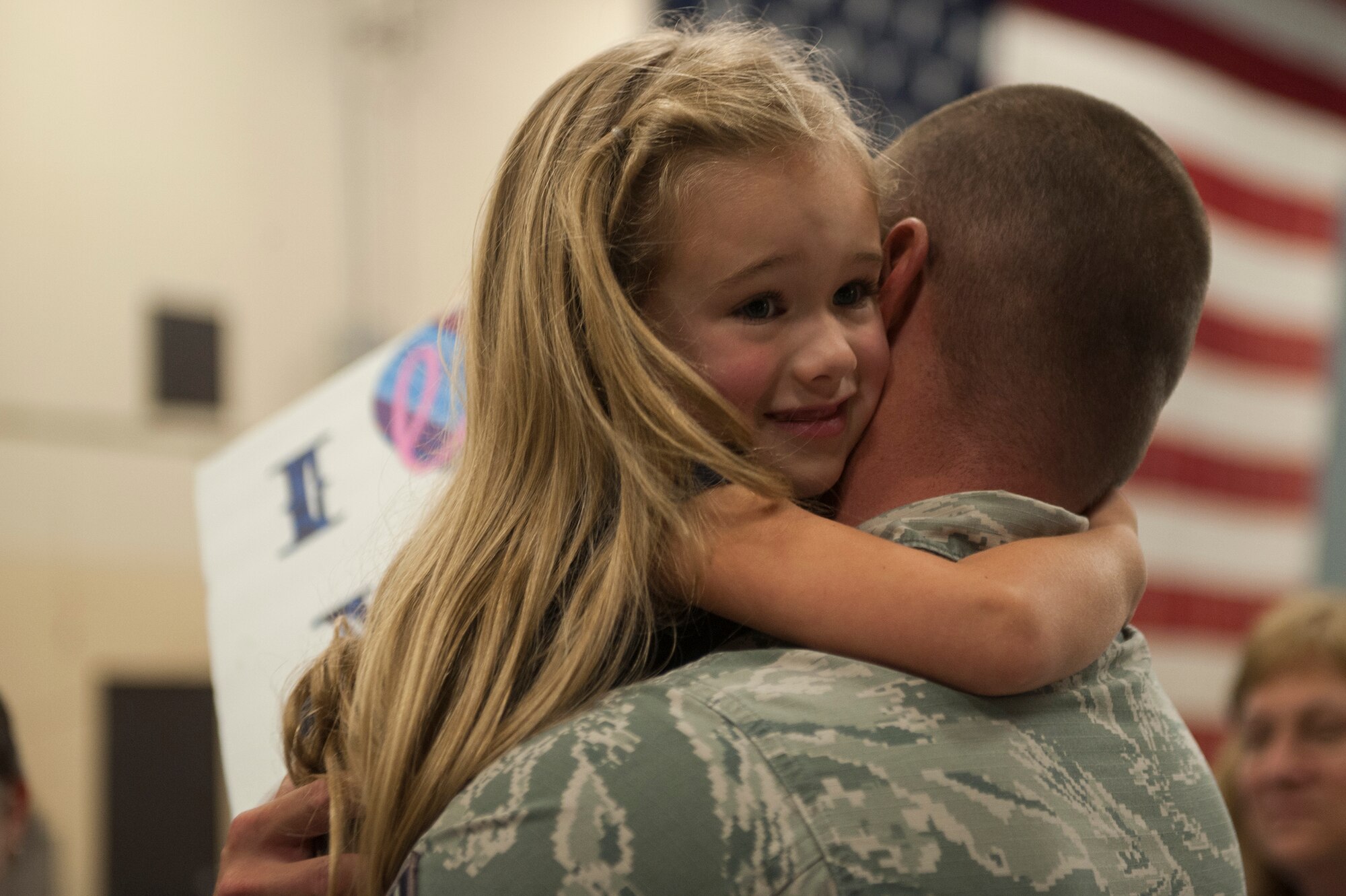 U.S. Air Force Staff Sgt. Dallas Ayers, 823d Base Defense Squadron unit deployment manager, embraces his daughter, Addison, during a re-deployment ceremony, Oct. 27, 2015, at Moody Air Force Base, Ga. The 820th Base Defense Group provides planning, training, equipping and preparation to three security forces squadrons, one of which is the 823d BDS. (U.S. Air Force photo by Airman 1st Class Kathleen D. Bryant/Released)
