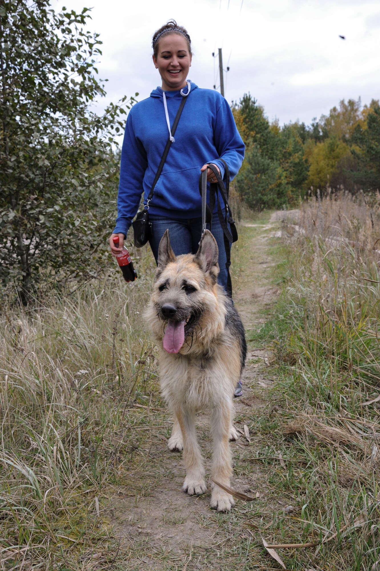 U.S. Air Force Airman 1st Class Lisa Wippel, 74th Expeditionary Fighter Squadron munitions systems conventional crew member, walks a homeless dog while volunteering at a local animal shelter in Tallinn, Estonia, Oct. 10, 2015. Wippel and other 74th EFS Airmen volunteered their off-duty time to walk and spend time with animals that are waiting for adoption. (U.S. Air Force photo by Andrea Jenkins/Released)