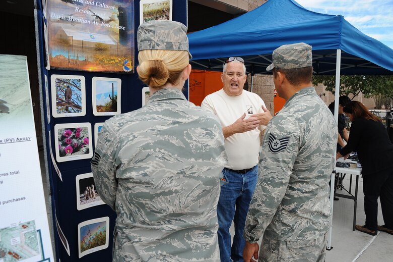 Kevin Wakefield, 355th Civil Engineer Squadron base natural and cultural resource manager, tells U.S. Air Force Tech. Sgt. Eric Godinez, 563rd Operations Support Squadron rescue aircraft flight equipment technician, and Tech. Sgt. Devon Godinez, 372nd Training Squadron, Detachment 11 NCO in charge of the instructor element, about the wild animals that live on Davis-Monthan Air Force Base, Ariz., during the Base Exchange Energy Day Oct. 28, 2015. Wakefield, along with representatives from Tucson Electric Power, Tucson Clean and Beautiful and other D-M AFB energy team members, informed Desert Lightning Team members about energy efficiency and awareness. The event was held to inform Desert Lightning Team members about energy efficiency and awareness. (U.S. Air Force photo by Airman 1st Class Mya M. Crosby/Released)