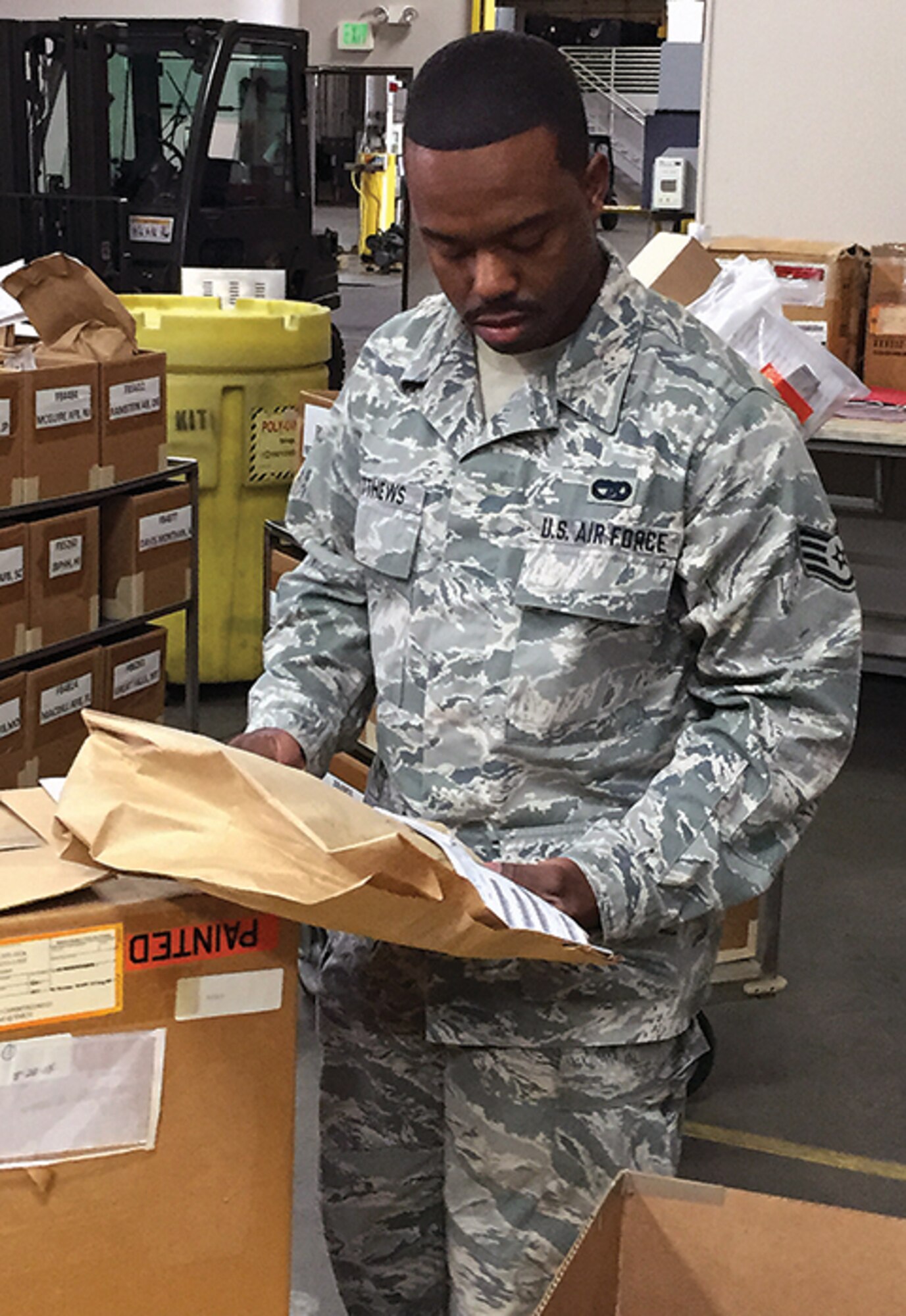 Staff Sgt. Derecus Matthews reviews received household goods information.