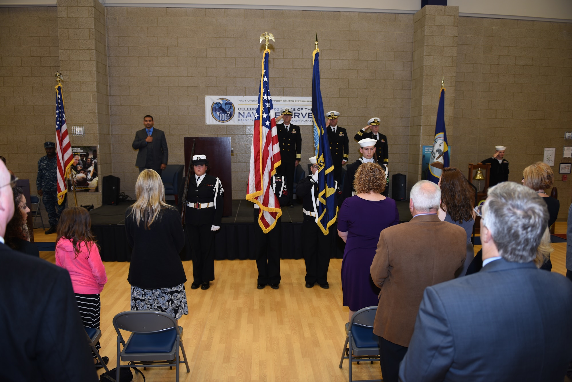 Sailors of Navy Operational Support Center - Pittsburgh and guests stand for the presentation of the colors during a change of command ceremony at the Pittsburgh International Airport Air Reserve Station, Oct. 3, 2015. Cmdr. Craig Frangente relinquished command to Cmdr. Donald G. Haley. (U.S. Air Force photo by Senior Airman Marjorie A. Bowlden)