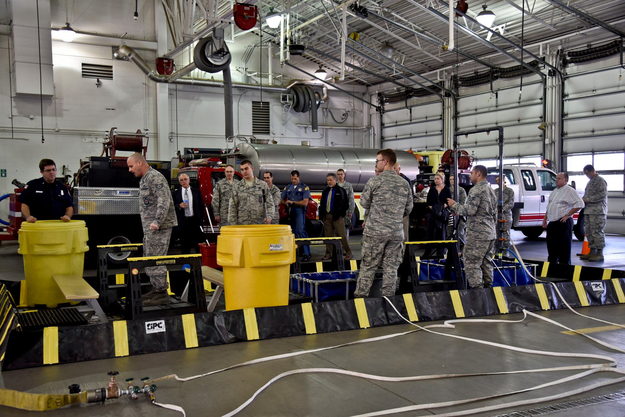 92nd Mission Support Group honorary commanders receive a hazardous material decontamination demonstration from the base fire department during a tour Oct. 27, 2015, at Fairchild Air Force Base, Wash. The Honorary Commander program’s purpose is to partner with and educate influential members of the community on the similarities and differences of military and civilian operations. (U.S. Air Force photo/Airman 1st Class Taylor Bourgeous)