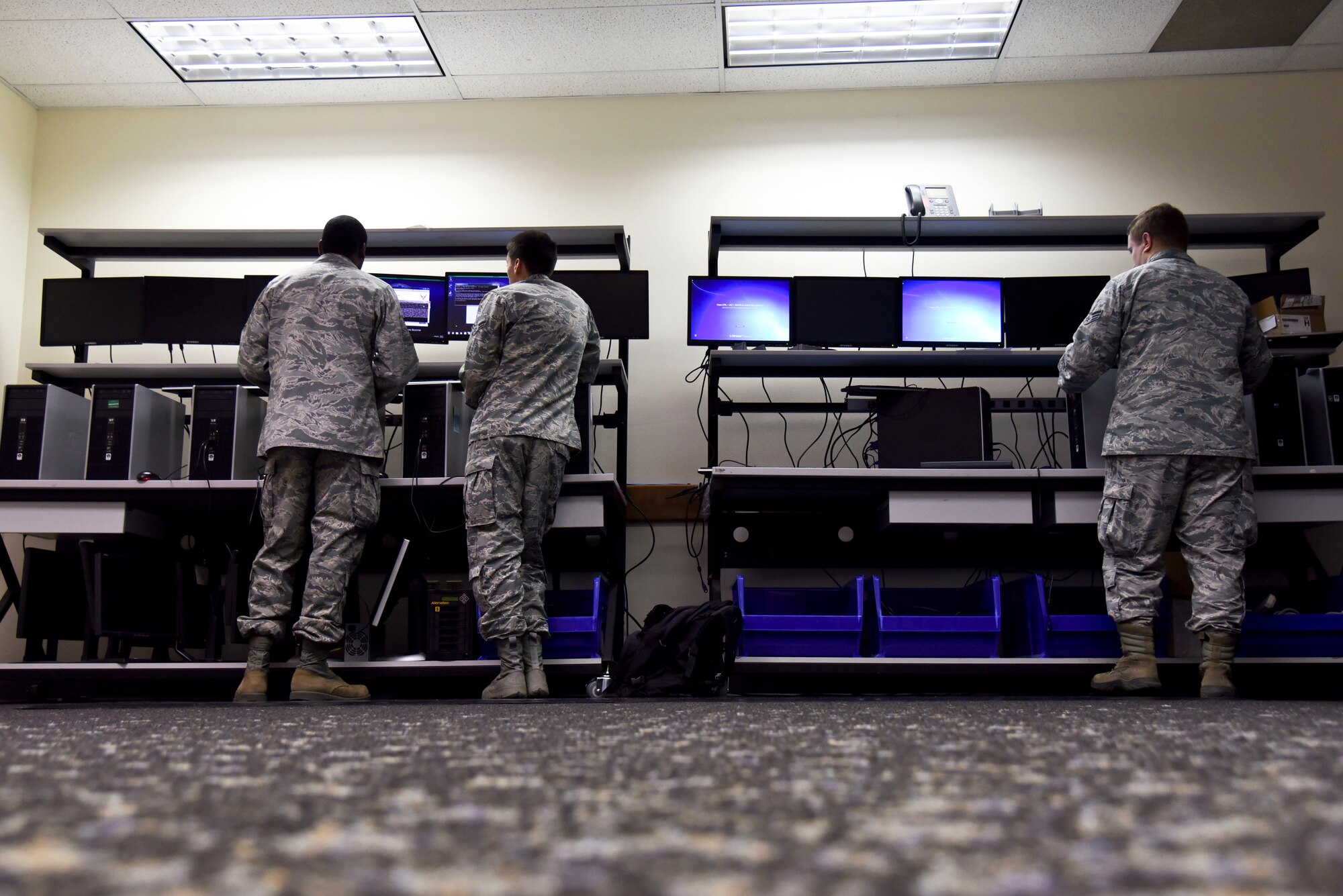 Airmen from the 92nd Communications Squadron run security patches on computers Oct. 29, 2015, at Fairchild Air Force Base, Wash. A big part of being a member of the 92nd CS is being able to provide the resources that Airmen need to accomplish their jobs and staying safe at the same time, said Senior Airman Dale Clark, 92nd CS client systems technician. (U.S. Air Force photo/Senior Airman Janelle Patiño)