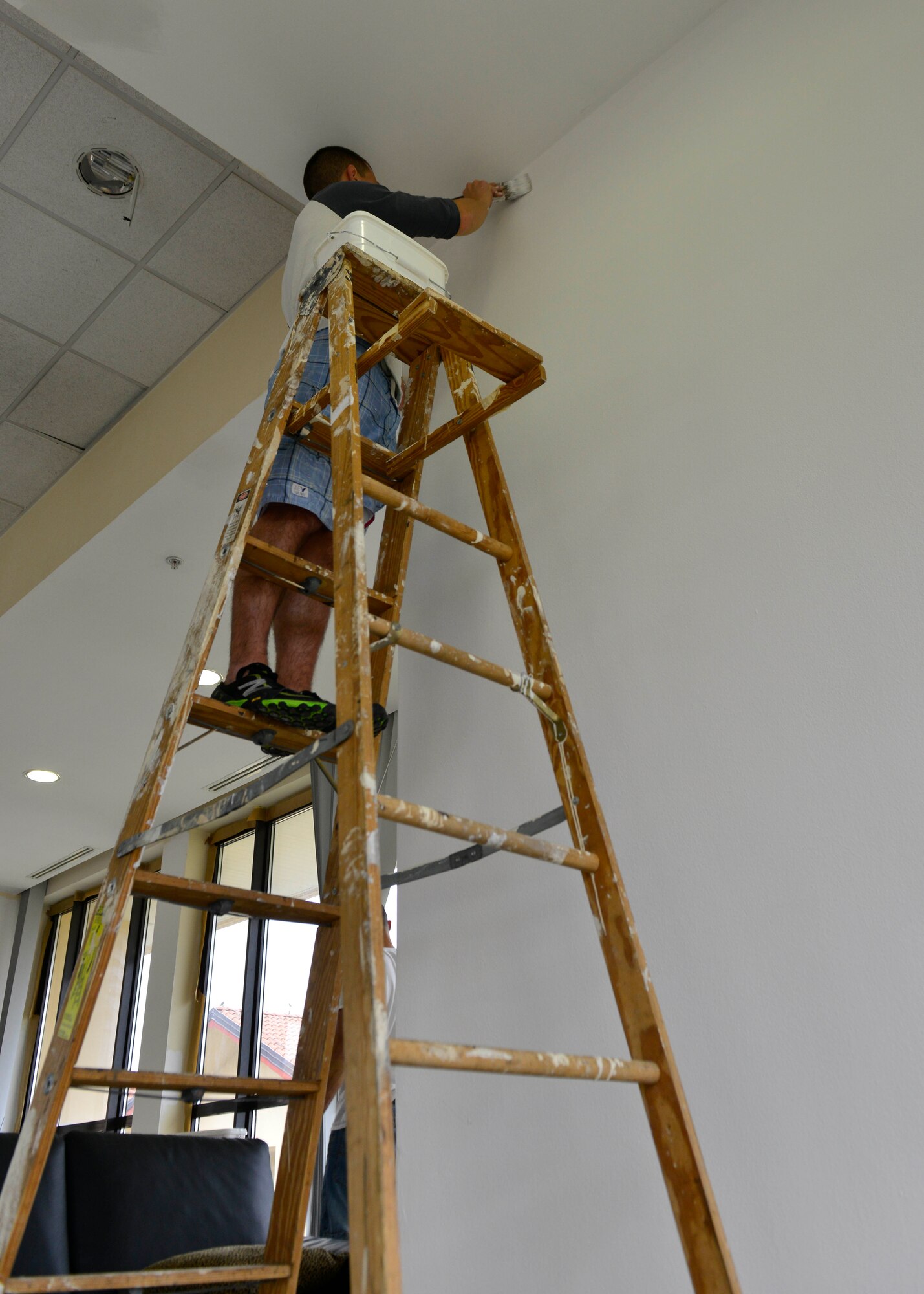 U.S. Air Force Airman 1st Class Kyle Yaklin, 31st Medical Operations Squadron mental health technician, paints a dormitory dayroom, Oct. 28, 2015, at Aviano Air Base, Italy. Renovations in the dorms will provide residents an updated atmosphere to socialize and relax in. (U.S. Air Force photo by Airman 1st Class Cary Smith/Released)