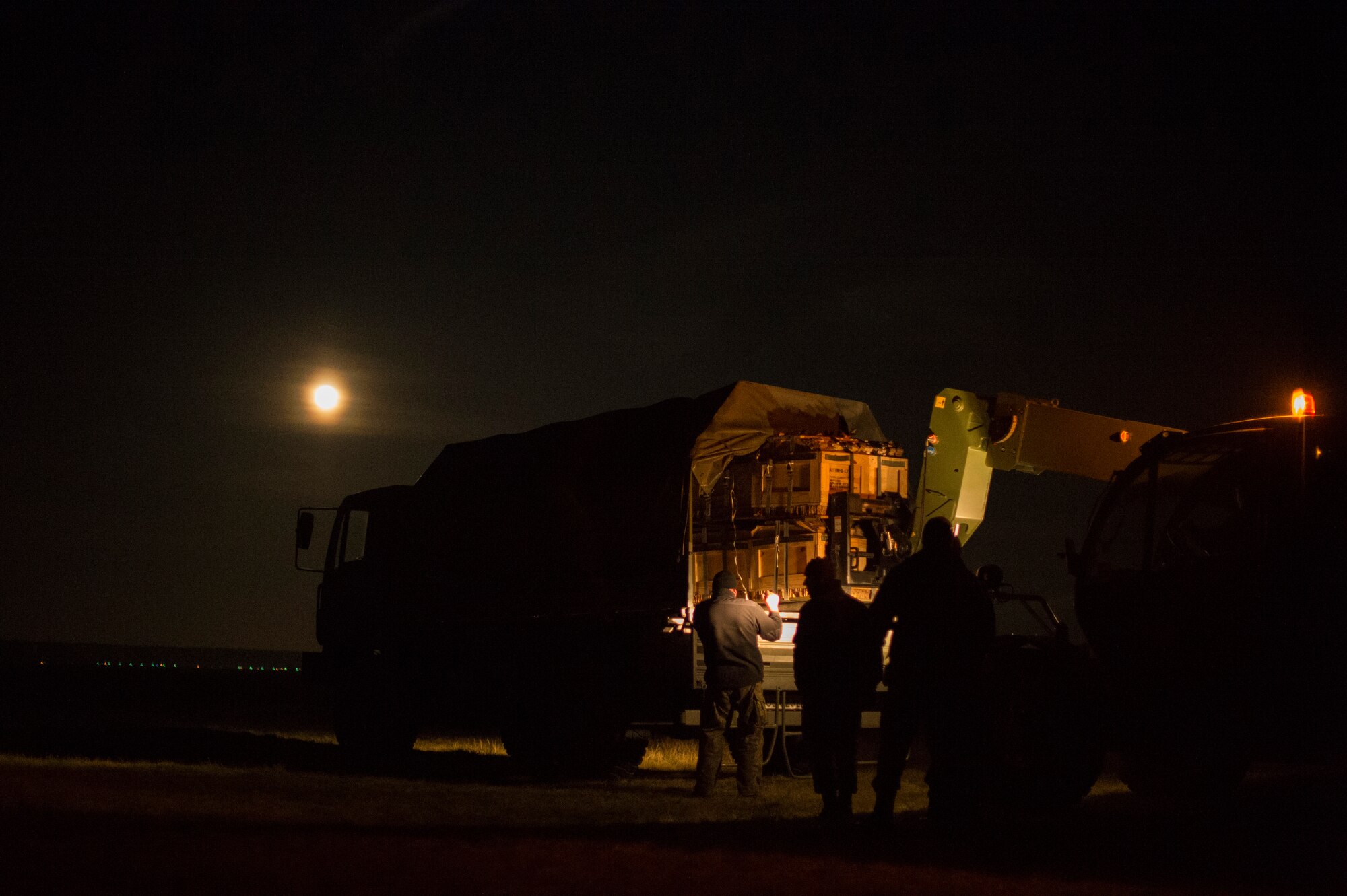Polish airmen recover a bundle during Aviation Detachment 16-1 Oct. 27, 2015, at Powidz Air Base, Poland. Throughout the flight training deployment, C-130s from the U.S. and Poland air forces worked together to perform training requirements such as multiple-element formation flying and realistic night vision goggle training. (U.S. Air Force photo/Senior Airman Damon Kasberg) 