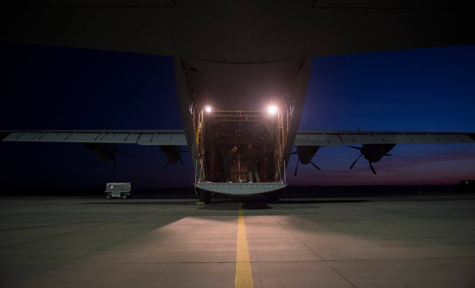 Staff Sgt. Robert Bowman, 86th Operation Support Squadron joint airdrop inspector, looks over a bundle prior to the aircrew performing night airdrops during Aviation Detachment 16-1 Oct. 27, 2015, at Powidz Air Base, Poland.  The training deployment gave Airmen from the 86th Airlift Wing an opportunity to work closely with the Polish air force, helping the NATO allies complete training requirements and build a better bond between both countries. (U.S. Air Force photo/Senior Airman Damon Kasberg)
