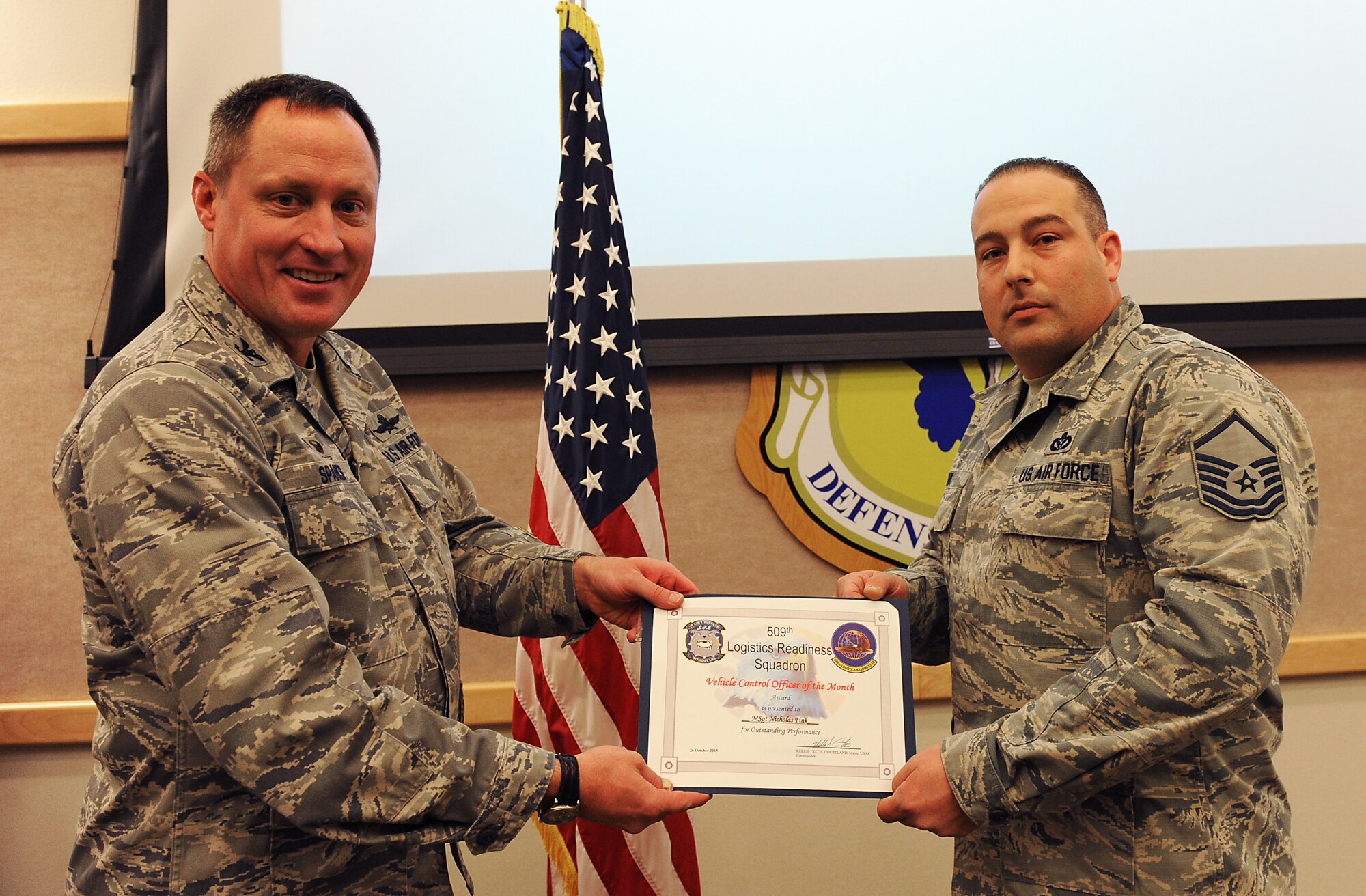 Master Sgt. Nicholas Fink, 509th Civil Engineer Squadron vehicle control, receives a Vehicle Control Officer (VCO) of the Month award at Whiteman Air Force Base, Mo., Oct. 26, 2015. Fink was the first Airman to receive the VCO of the Month award as it was recently developed to show appreciation to those who show excellence in maintaining government vehicles. (U.S. Air Force photo by Airman 1st Class Michaela R. Slanchik/Released)