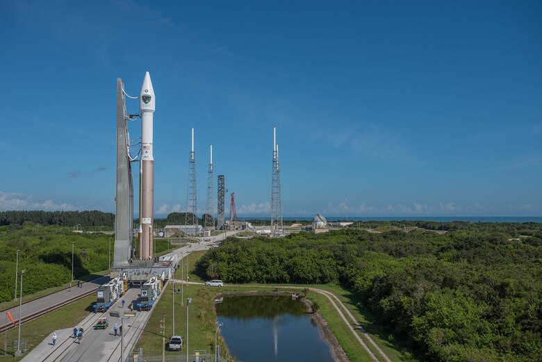 A wide angle view of the Atlas V 401 launch vehicle with GPS IIF-11 satellite aboard is rolled from the Vertical Integration Facility to Space Launch Complex-41 in anticipation of a Saturday afternoon launch from Cape Canaveral Air Force Station, Fla. The launch window opens Oct. 31 at 12:13 EDT (9:13 a.m. PDT). This is the second to last GPS IIF launch in a series of 12 spacecraft. The gray structure in the distance just to the left of the red construction crane is a new Crew Access Tower, currently nearing completion for future use by astronauts with the Boeing CST-100 manned spacecraft, slated for first flight in December 2017. (Photo courtesy United Launch Alliance).