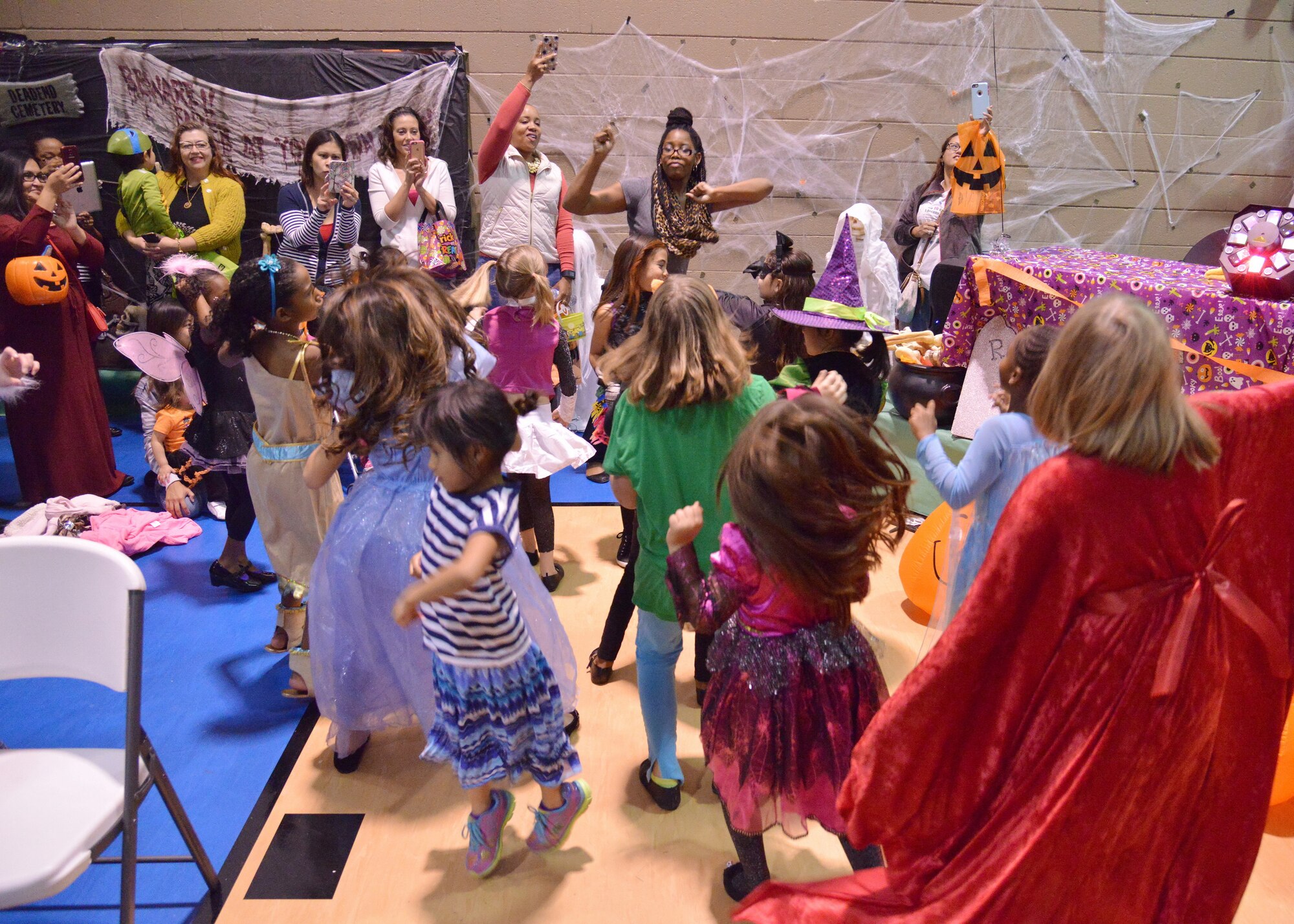 Adults and kids dance during Bootastic Oct. 23 at the Youth Center.. The annual Halloween event provided a free night of games, prizes, safe trick-or-treating and other fun events for people of all ages. (Photo by Jamie Burnett)