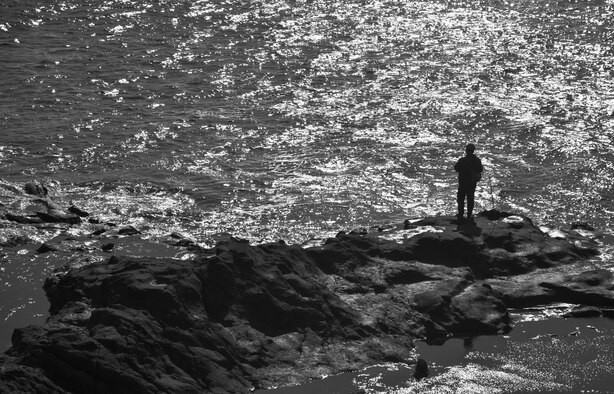 A Japanese man fishes on the Chigogafuchi Marine Plateau at Enoshima Island in Fujisawa City, Japan, Oct. 25, 2015. This plateau is one of 16 different tourist sites on the island. (U.S. Air Force photo by Senior Airman David Owsianka/Released)