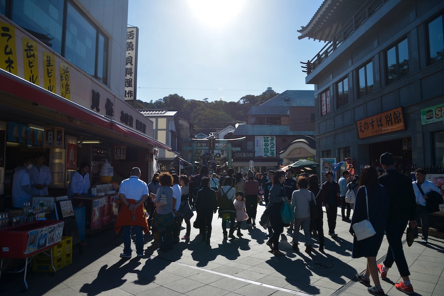 People walk throughout the streets of Enoshima Island in Fujisawa City, Japan, Oct. 25, 2015. The island has pathways that lead to several ancient temples and shrines, botanical gardens, museums, parks, caves and a lighthouse at the top of the island. (U.S. Air Force photo by Senior Airman David Owsianka/Released)