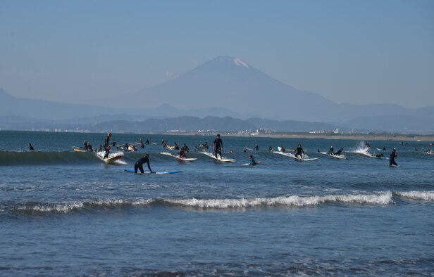 People surf in Sagami Bay in Fujisawa City, Japan, Oct. 25, 2015. Sagami Bay uses the Kuroshio Current to warm the bay, allowing it to host marine organisms typical of more southerly regions and giving a mild climate to the land bordering it. (U.S. Air Force photo by Senior Airman David Owsianka/Released)