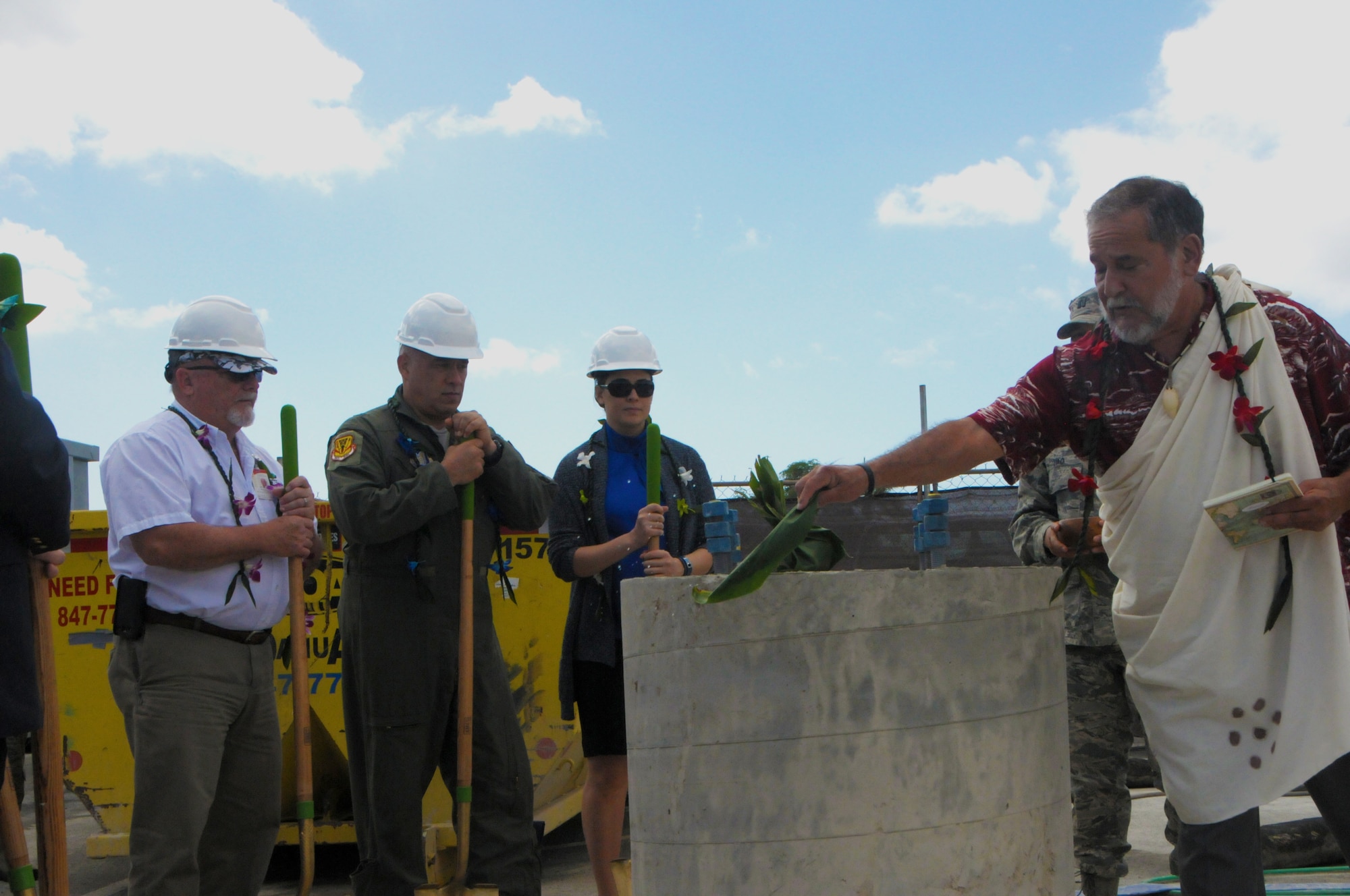 Officials for the Hawaii Air National Guard look on as Hawaiian Kahu or priest Roy Brooks performs a traditional Hawaiian blessing on the cornerstone pillar of a future solar array facility being built at Joint Base Pearl Harbor-Hickam,Oct. 27, 2015. The solar array facility will be one piece of the HIANG's renewable energy strategy to decrease it's electricity expense and increase it's energy security. (U.S.Air National Guard photo by Senior Airman Orlando Corpuz/Released)