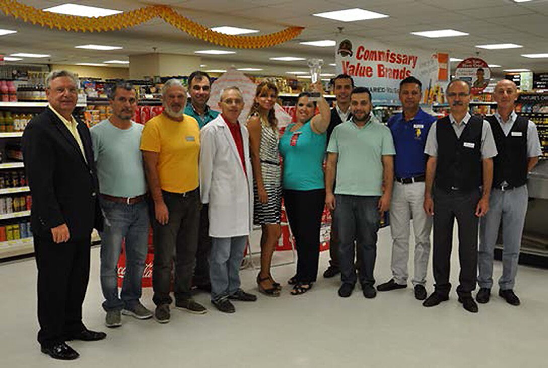 Tuğçe Şenliler, Izmir commissary customer service, and Izmir commissary  personnel pose for the camera with their award Aug. 26, 2015. Izmir commissary won the L. Mendel Rivers Award as the Defense Commissary  Agency’s best small commissary overseas for 2014, announced by DECA Aug. 20, 2015. (U.S. Air Force photo by Tanju Varlikli)
