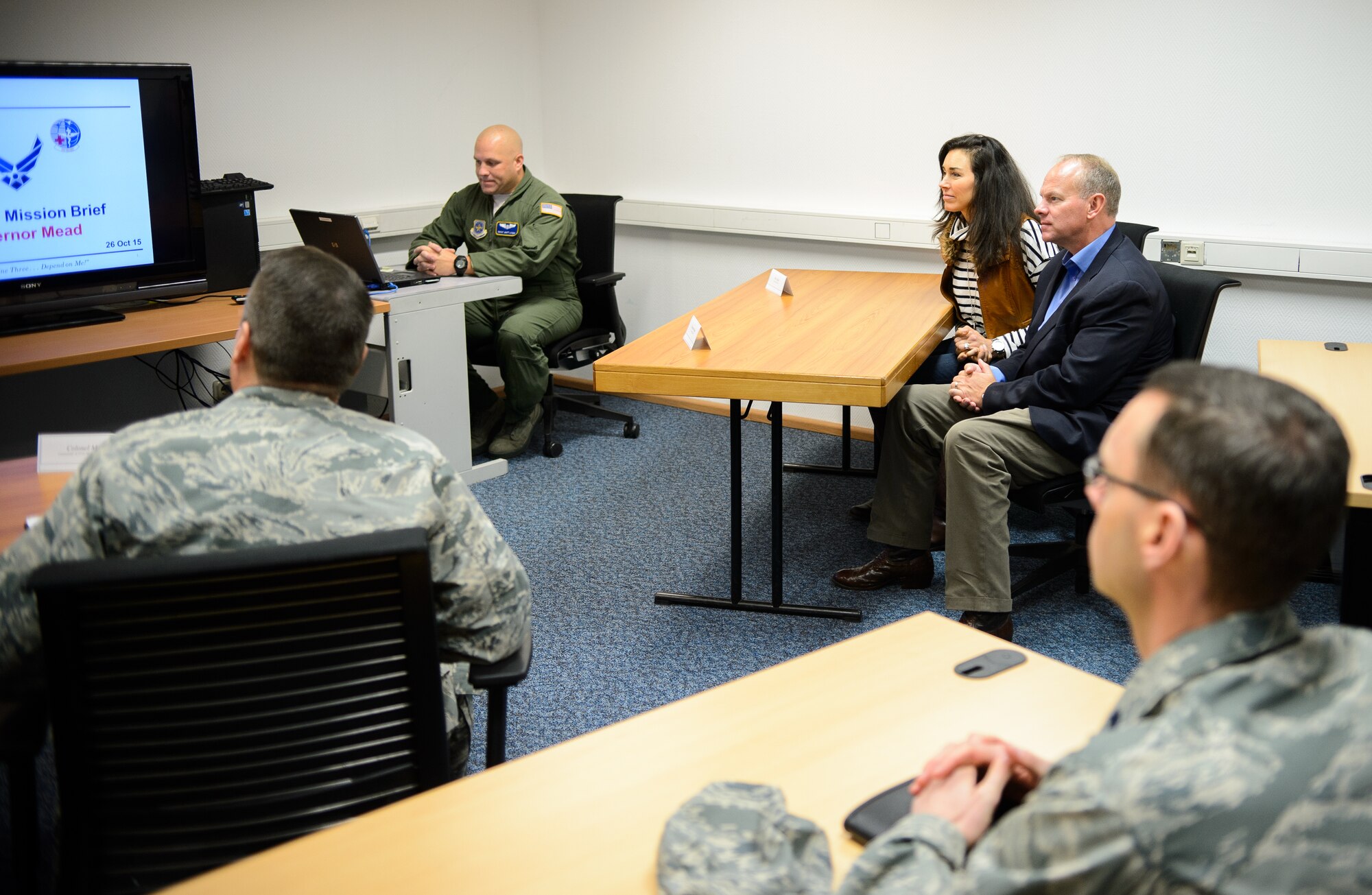 Wyoming Governor Matt Mead and his wife, Carol, listen to the 10th Expeditionary Aeromedical Evacuation Squadron commander’s brief on the operations conducted by the Wyoming Airmen deployed to the 10th EAES Oct. 26, 2015, at Ramstein Air Base, Germany. Twelve Airmen from the Wyoming Air National Guard joined active-duty and reserve Airmen throughout the year in saving more than 2,500 lives. (U.S. Air Force photo/Staff Sgt. Armando A. Schwier-Morales)