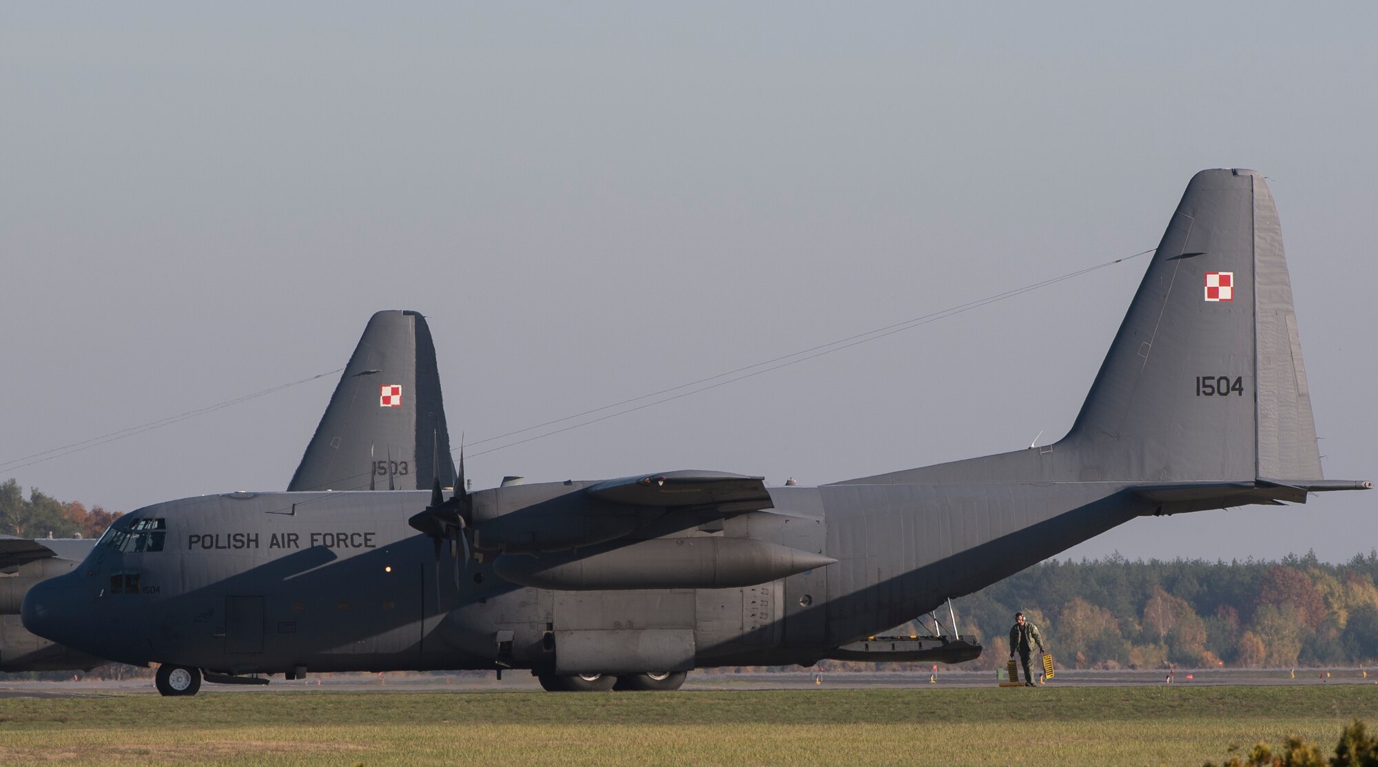 Polish airmen park a C-130E Legacy after completing a five-ship-formation flight with the 86th and 182nd Airlift Wings during Aviation Detachment 16-1 Oct. 27, 2015, at Powidz Air Base, Poland.  The training allowed the allies to work within the NATO construct, enhancing their abilities to respond to future challenges. (U.S. Air Force photo/Senior Airman Damon Kasberg)