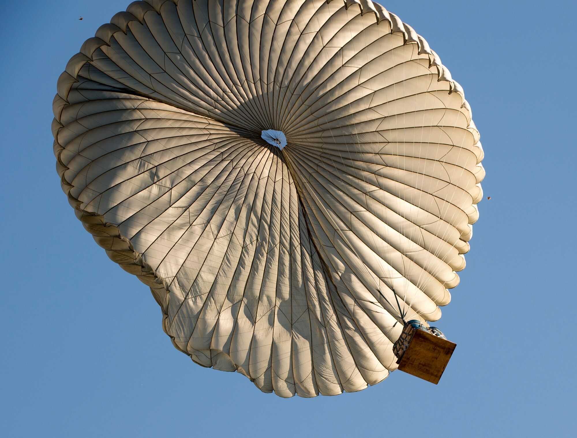 A container delivery system parachutes toward the ground Oct. 27, 2015, at Powidz Air Base, Poland.  The CDS was airdropped from a C-130H Hercules assigned to the 169th Airlift Squadron, who deployed to Poland to participate in Aviation Detachment 16-1. (U.S. Air Force photo/Senior Airman Damon Kasberg)