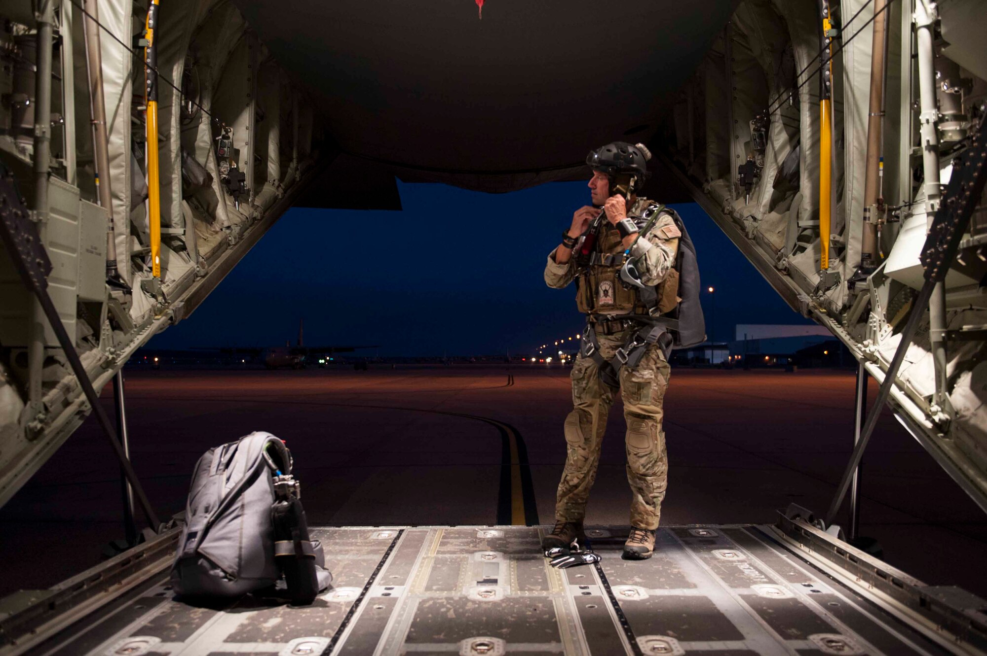 U.S. Air Force Lt. Col. Timothy Stout, 19th Aerospace Medicine Squadron High Altitude Airdrop Mission Support center director, dons his gear prior to a training jump Oct. 21, 2015, on Little Rock Air Force Base, Ark. Stout is responsible for training and equipping HAAMS technicians ensuring combat readiness. (U.S. Air Force photo by Senior Airman Kaylee Clark)  