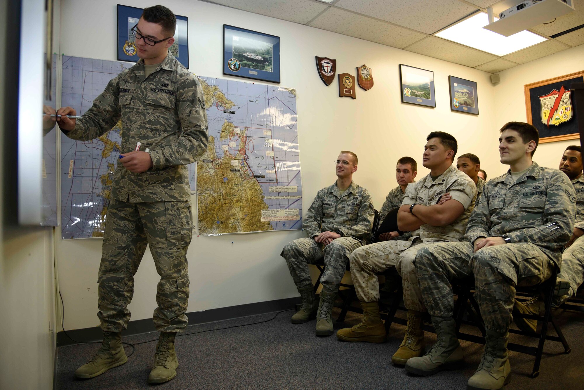 U.S. Air Force Airman Ryan Toerner, 610 Air Control Flight weapons director technician, briefs Airmen at Misawa Air Base, Japan, Oct. 29, 2015. These briefings are done to inform four to 12 people of the Suppression of Enemy Air Defenses mission. (U.S. Air Force photo by Airman 1st Class Jordyn Fetter/Released)
