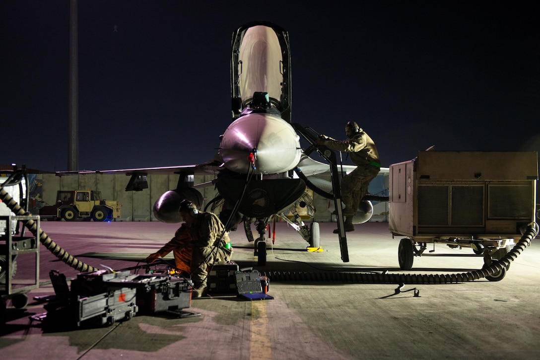 U.S. Air Force Tech. Sgt. Jesus Menacho climbs out of an F-16 Fighting Falcon while performing maintenance on the aircraft on Bagram Airfield, Afghanistan, Oct. 28, 2015. Menacho is assigned to the 455th Expeditionary Aircraft Maintenance Squadron. U.S. Air Force photo by Tech. Sgt. Joseph Swafford