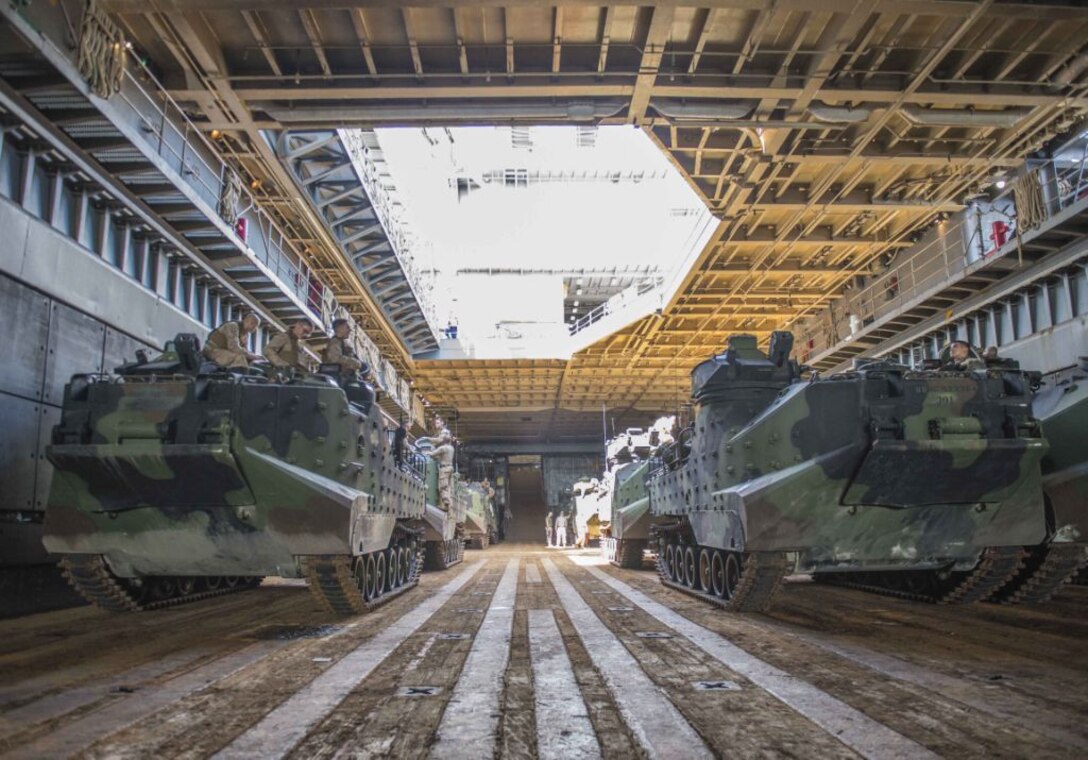 WATERS OFF OKINAWA, Japan – Amphibious assault vehicles wait in the well deck of the amphibious dock landing ship USS Germantown (LSD 42) before launching to head ashore for a personnel swap during exercise Blue Chromite (BC) 16. BC 16 is a U.S. only exercise designed to increase amphibious proficiency between the Navy and Marine Corps. (U.S. Navy photo by Mass Communication Specialist 2nd Class Will Gaskill/Released) 