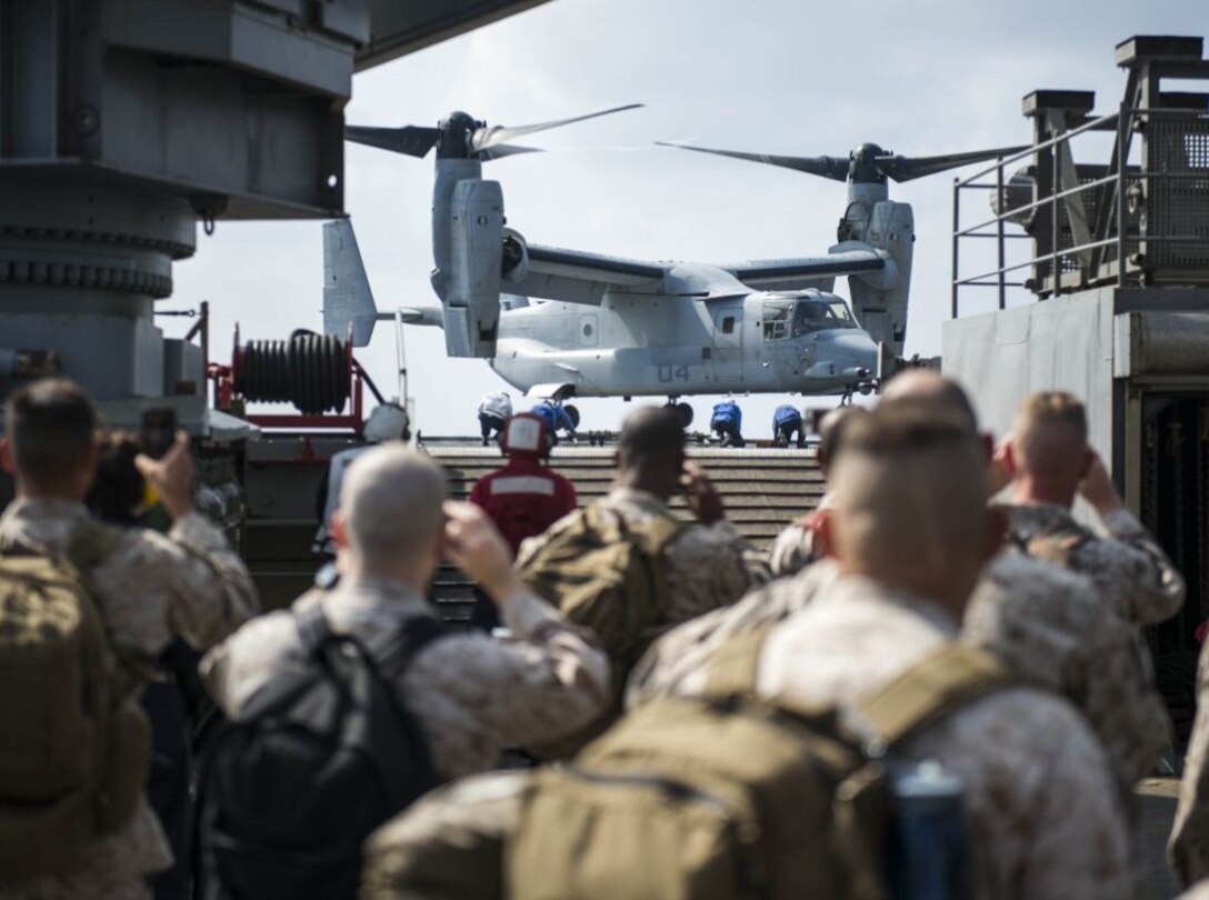 WATERS OFF OKINAWA, Japan – Sailors and Marines look on while a MV-22 Osprey aircraft lands on the flight deck aboard the amphibious dock landing ship USS Germantown (LSD 42) during exercise Blue Chromite (BC) 16. BC 16 is a U.S. only exercise designed to increase amphibious proficiency between the Navy and Marine Corps. (U.S. Navy photo by Mass Communication Specialist 2nd Class Will Gaskill/Released) 