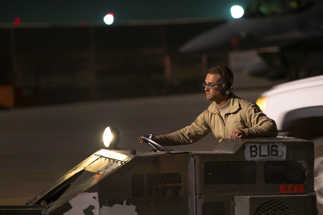U.S. Air Force Senior Airman Brandon Goodrich drives across the flightline on Bagram Airfield, Afghanistan, Oct. 28, 2015. Goodrich is an aircraft armament technician assigned to the 455th Expeditionary Aircraft Maintenance Squadron. U.S. Air Force photo by Tech. Sgt. Robert Cloys