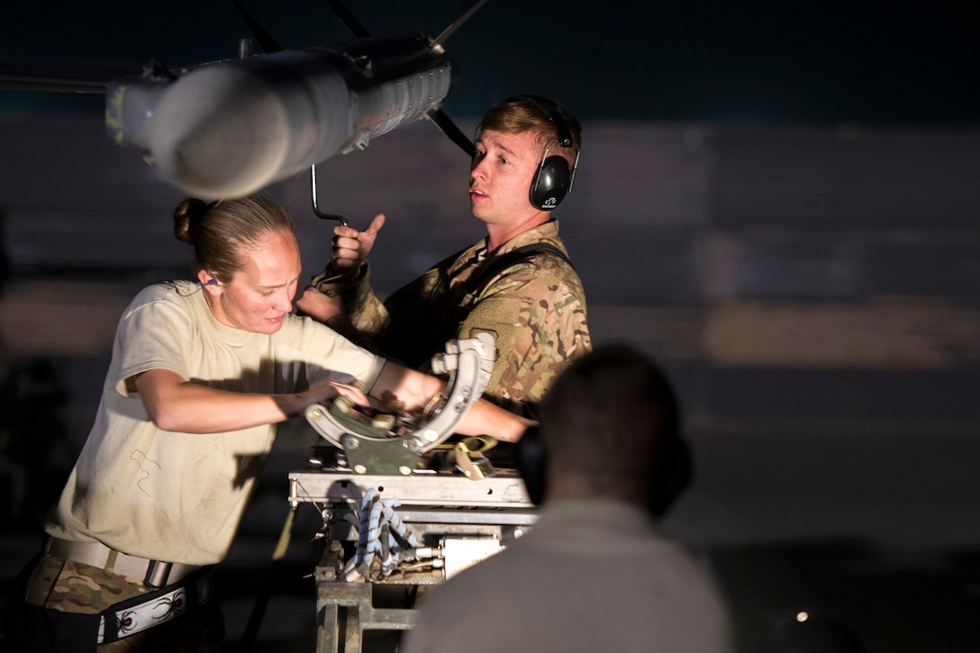 U.S. Air Force Staff Sgt. Jeanette Martinez, left, and Senior Airman Christopher Wessig load a missile onto an F-16 Fighting Falcon on Bagram Airfield, Afghanistan, Oct. 28, 2015. Martinez, a weapons team chief, and Wessig are assigned to the 455th Expeditionary Aircraft Maintenance Squadron. U.S. Air Force photo by Tech. Sgt. Robert Cloys