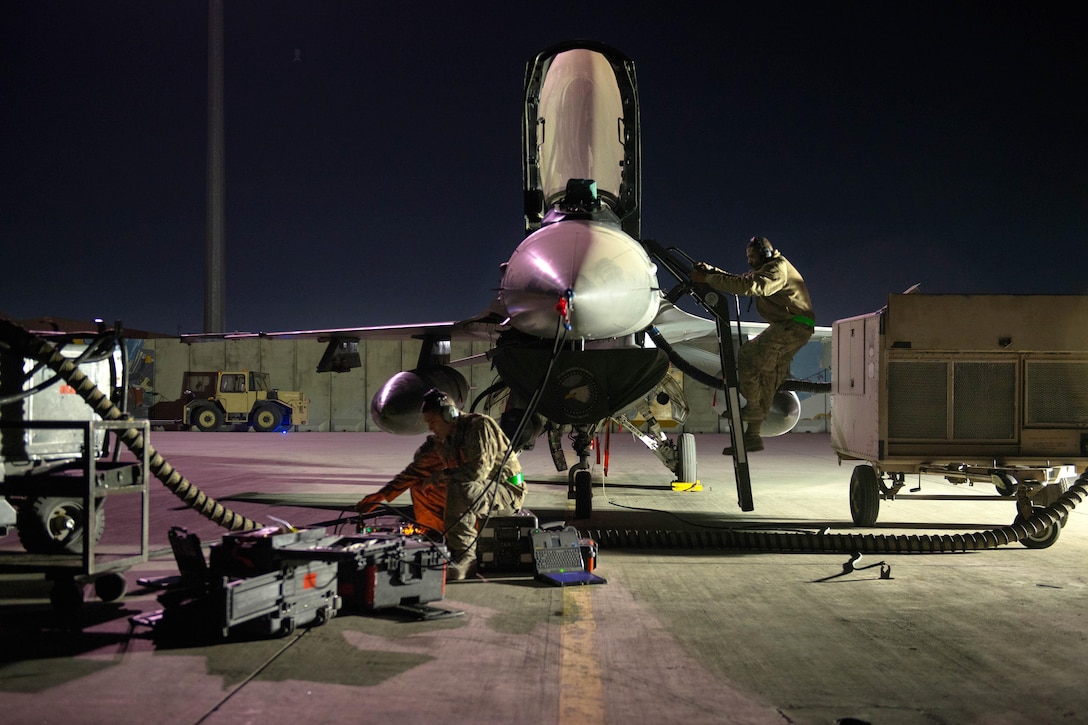 U.S. Air Force Tech. Sgt. Jesus Menacho climbs out of an F-16 Fighting Falcon while performing maintenance on the aircraft on Bagram Airfield, Afghanistan, Oct. 28, 2015. Menacho is assigned to the 455th Expeditionary Aircraft Maintenance Squadron. U.S. Air Force photo by Tech. Sgt. Joseph Swafford