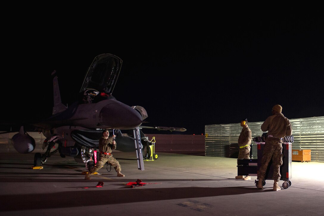 U.S. airmen perform maintenance on an F-16 Fighting Falcon on Bagram Airfield, Afghanistan, Oct. 28, 2015. U.S. Air Force photo by Tech. Sgt. Joseph Swafford
