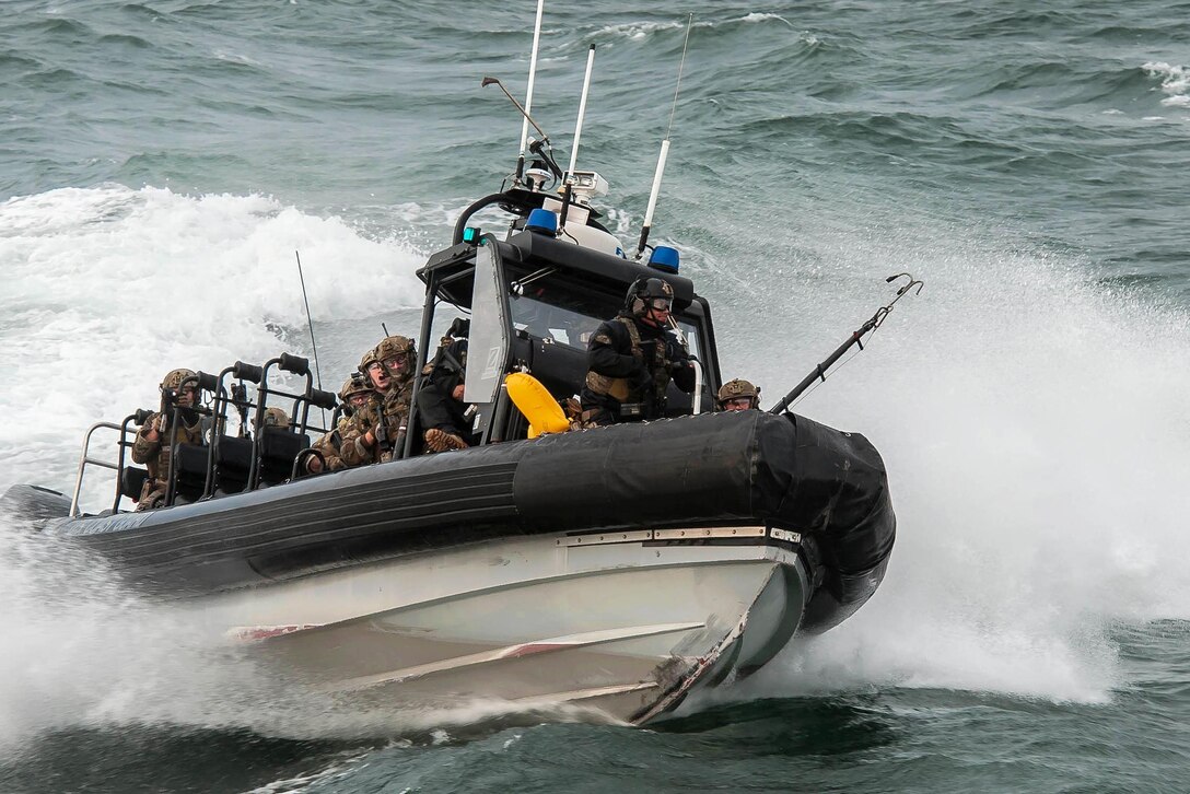 Coast Guardsmen ride in a rigid-hull inflatable boat while training in Hyannis, Mass., Oct., 22, 2015. The guardsmen, assigned to the Maritime Security Response Team from Virginia, practiced tactical boardings at sea, active shooter scenarios and detecting radiological material. U.S. Coast Guard photo by Petty Officer 3rd Class Ross Ruddell
