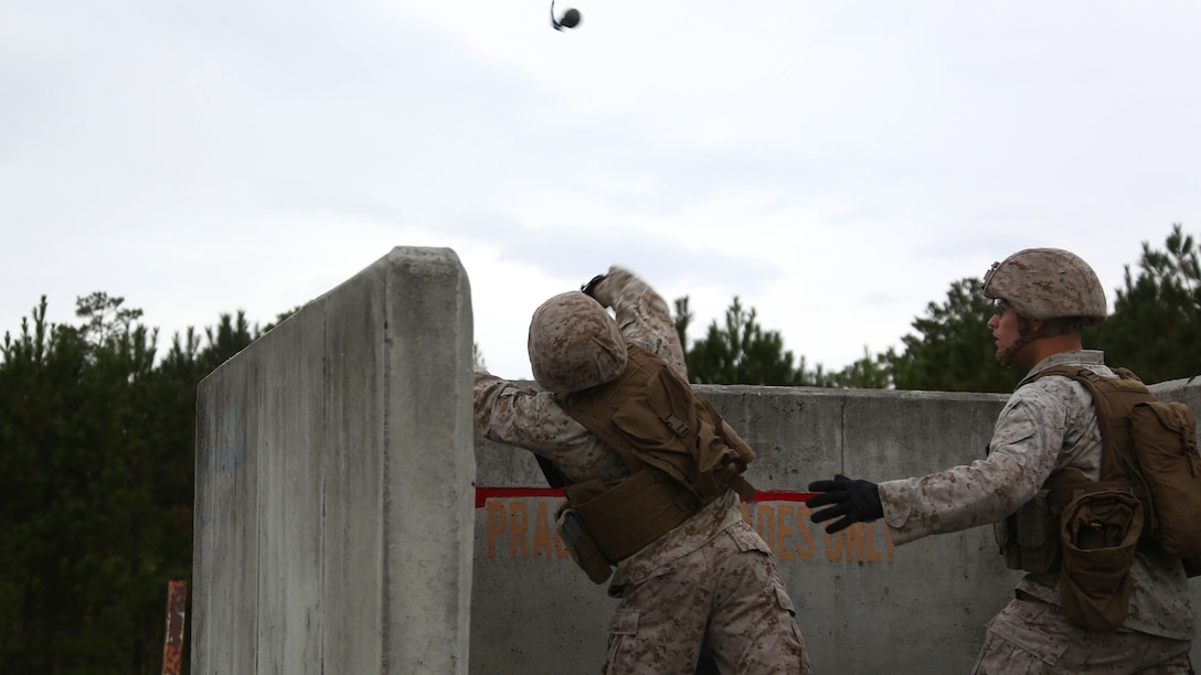 A Marine throws an M67 fragmentation grenade during a grenade and MK19 Grenade Launcher range at Marine Corps Base Camp Lejeune, N.C., Oct. 28, 2015. More than 70 Marines with 2nd Low Altitude Air Defense Battalion took turns handling the MK19 and handheld grenades during the familiarization range. The range offered Marines the opportunity to build confidence and proficiency skills on some of the crew-served weapons they operate while providing security in a deployed environment. 