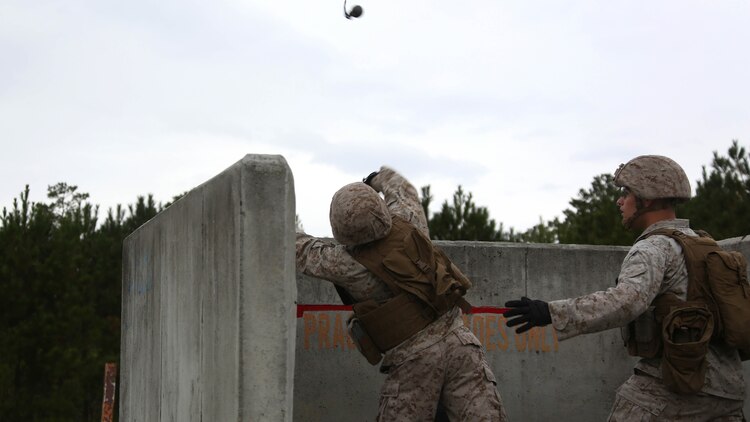 A Marine throws an M67 fragmentation grenade during a grenade and MK19 Grenade Launcher range at Marine Corps Base Camp Lejeune, N.C., Oct. 28, 2015. More than 70 Marines with 2nd Low Altitude Air Defense Battalion took turns handling the MK19 and handheld grenades during the familiarization range. The range offered Marines the opportunity to build confidence and proficiency skills on some of the crew-served weapons they operate while providing security in a deployed environment. 