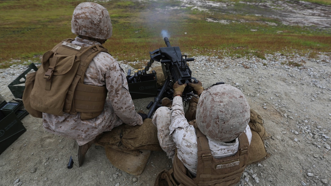 Lance Cpl. Arismendy Reynoso observes targets as Lance Cpl. Johnathan Velasco engages them during a grenade and MK19 Grenade Launcher range at Marine Corps Base Camp Lejeune, N.C., Oct. 28, 2015. More than 70 Marines with 2nd Low Altitude Air Defense Battalion took turns handling the MK-19 and handheld grenades during the familiarization range. The range offered Marines the opportunity to build confidence and proficiency skills on some of the crew-served weapons they operate while providing security in a deployed environment. Reynoso and Velasco are both low altitude aerial defense gunner with the battalion. 