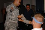 A Maryland Army National Guard member show members of the Baltimore District Drug Enforcement Administration life saving skills during a combat first aid class hosted by the Maryland National Guard Oct. 3 to 7, 2011.