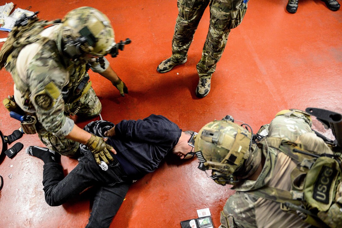 Coast Guardsmen detain a passenger while training in Hyannis, Mass., Oct., 22, 2015. U.S. Coast Guard photo by Petty Officer 3rd Class Ross Ruddell

