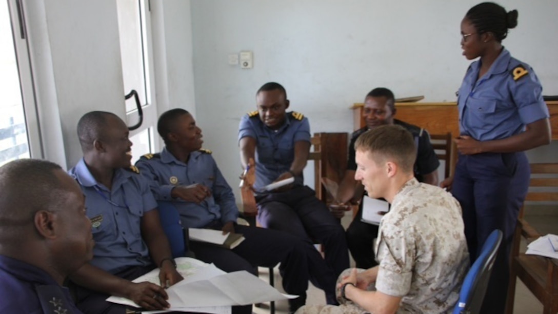 U.S. Marine Capt. Jeremy Phillips, the intelligence security cooperation Officer with Special-Purpose Marine Air-Ground Task Force Crisis Response-Africa, discuss intelligence gathering with Ghanaia Navy intelligence at Ghana’s Navy Trade Training School in Sekondi, Ghana, Oct. 19. U.S. forces completed a Tactical Intelligence Support To Maritime Operations Centers “train-the-trainer” course for the Ghanaian Navy from Oct. 12-23. This two-week introduction to intelligence was the first of four planned for the fiscal year.  U.S. Navy and Marine Corps service members taught Sixteen Ghanaian sailors, along with two senior members of Ghana’s Marine Police Unit of the Ghana Police Service. The course was designed as both an introduction to the intelligence process, particularly in support of their MOCs, and to prepare the students to become intelligence instructors for the Ghanaian Navy’s internal intelligence courses.