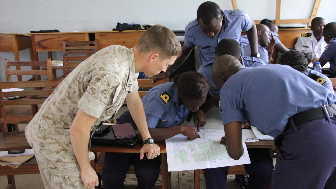 U.S. Marine Capt. Jeremy Phillips, the intelligence security cooperation Officer with Special-Purpose Marine Air-Ground Task Force Crisis Response-Africa, discusses intelligence gathering with Ghanaia Navy intelligence at Ghana’s Navy Trade Training School in Sekondi, Ghana, Oct. 19. U.S. forces completed a Tactical Intelligence Support To Maritime Operations Centers “train-the-trainer” course for the Ghanaian Navy from Oct. 12-23. This two-week introduction to intelligence was the first of four planned for the fiscal year.  U.S. Navy and Marine Corps service members taught Sixteen Ghanaian sailors, along with two senior members of Ghana’s Marine Police Unit of the Ghana Police Service. The course was designed as both an introduction to the intelligence process, particularly in support of their MOCs, and to prepare the students to become intelligence instructors for the Ghanaian Navy’s internal intelligence courses.