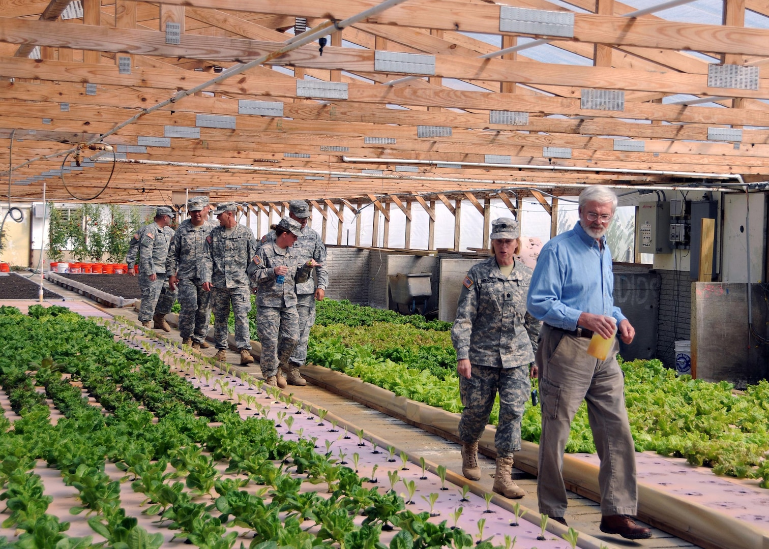 Jim Moseley, a farmer and former deputy secretary of agriculture gives Soldiers and Airmen from the 3-19th Indiana Agribusiness Development Team, a tour of his hydroponics farm on Sept. 3, 2011, as part of their mobilization training at Camp Atterbury. The meeting was designed to give the service members a better understanding of Afghanistan before their scheduled deployment to Afghanistan in early fall this year.