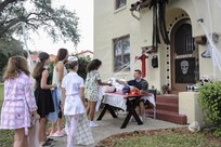 Ensign Cayce Stepp and his family, Joint Base San Antonio-Randolph housing residents, hand out candy during Halloween trick-or-treating Oct. 29, 2015 at JBSA-Randolph. The Stepp family also created a Haunted Trail throughout their backyard for the kids to take part in.  All JBSA locations hold their trick-or-treating during specific hours for the safety of the children and their families. (U.S. Air Force photo by Melissa Peterson/Released)