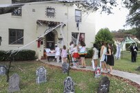 Ensign Cayce Stepp and his family, Joint Base San Antonio-Randolph housing residents, hand out candy during Halloween trick-or-treating Oct. 29, 2015 at JBSA-Randolph. The Stepp family also created a Haunted Trail throughout their backyard for the kids to take part in.  All JBSA locations hold their trick-or-treating during specific hours for the safety of the children and their families. (U.S. Air Force photo by Melissa Peterson/Released)