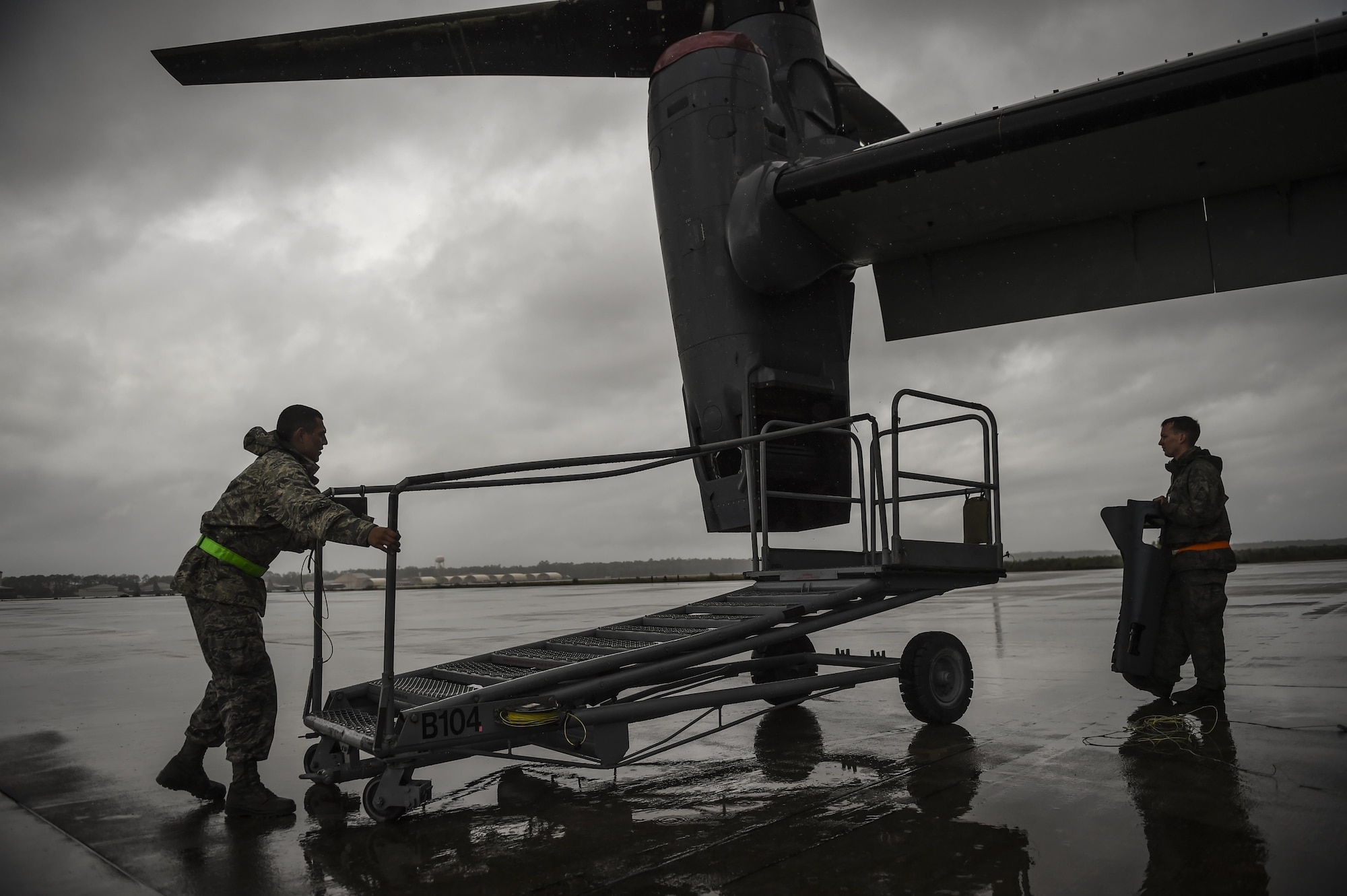 Airman 1st Class Joseph Cervantes, 801st Special Operations Aircraft Maintenance Squadron crew chief, positions air stairs next to a CV-22B Osprey engine for routine maintenance at Hurlburt Field, Fla., Oct. 27, 2015.  The 801st SOAMXS’s mission is to perform all equipment maintenance in support of worldwide special operations missions. (U.S. Air Force photo by Senior Airman Christopher Callaway/Released)